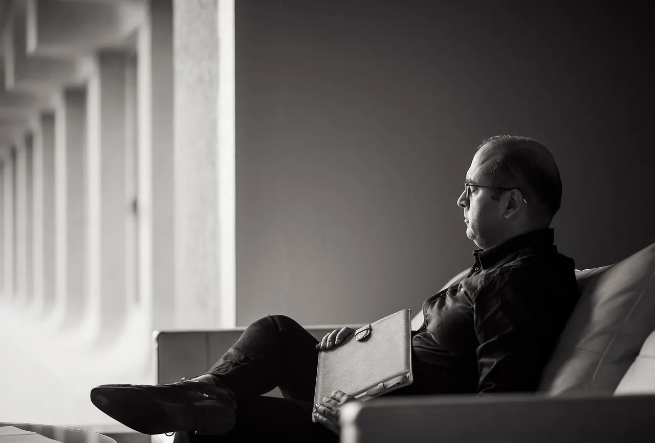 Professional sitting with a portfolio, reviewing his author credentials before a guest post submission
